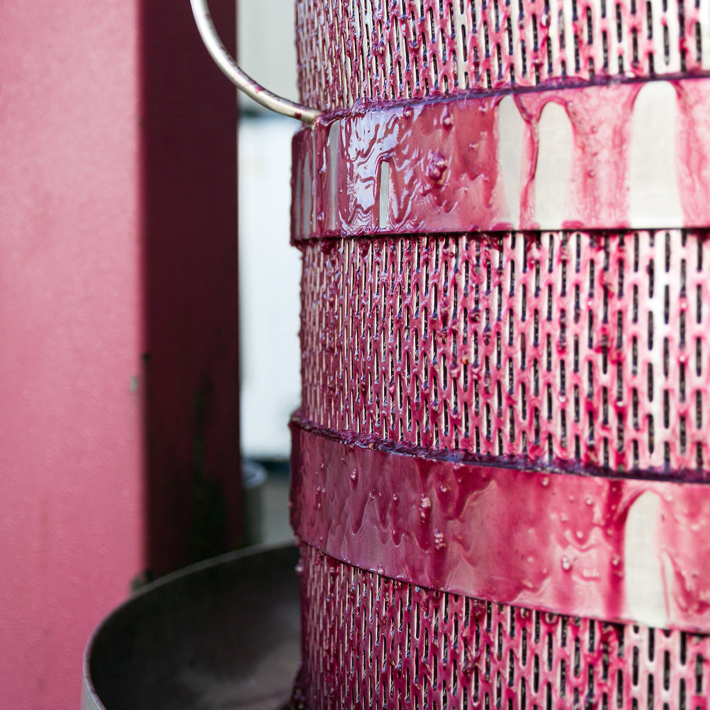 Wine press with wine on it