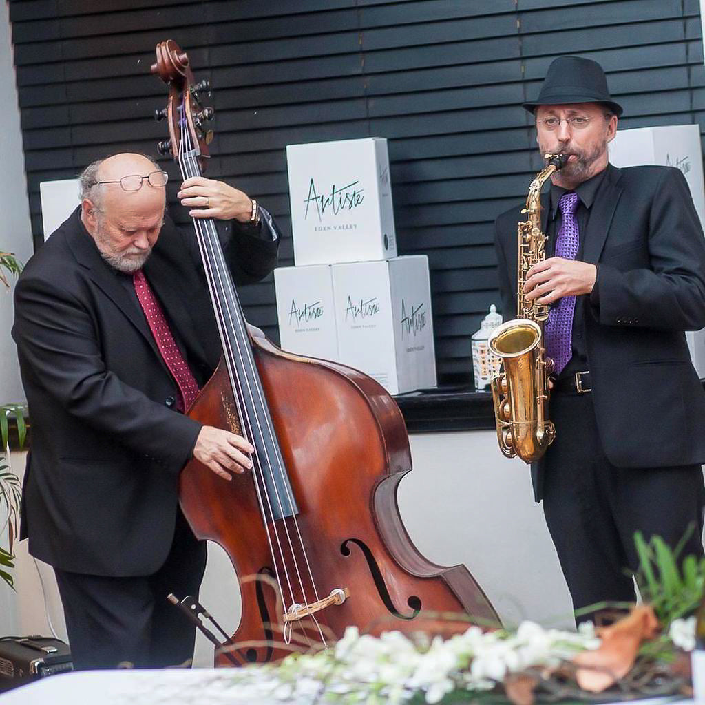 Man playing double bass and man playing alto saxophone