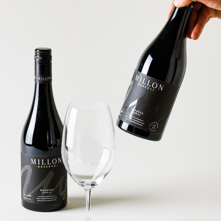 Two bottles of Millon Wines Reserve 2020 Shiraz and wine glass